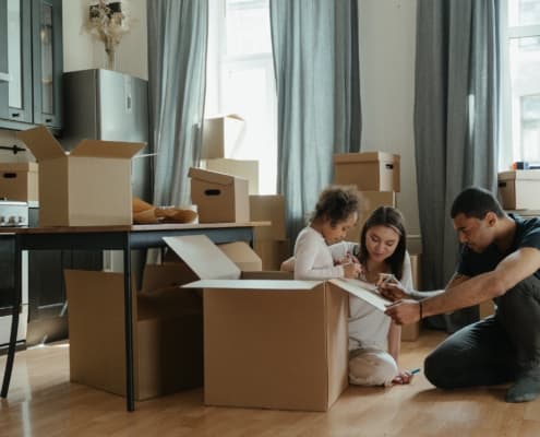 A photo of a family moving in; screening your tenants.