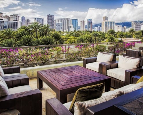 A terrace of a condo overlooking a city with big buildings.
