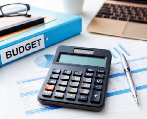 Financial and budget planning concept with calculator laptop and financial report
