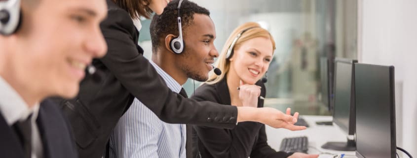 Side view of female manager assisting her staffs in a call center.