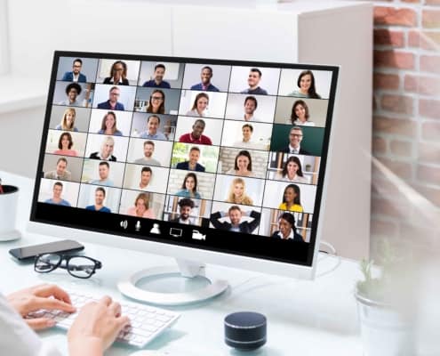 A woman on a video call with several other people. Read tips on how to increase attendance in Board Meetings, including tips on virtual meetings.