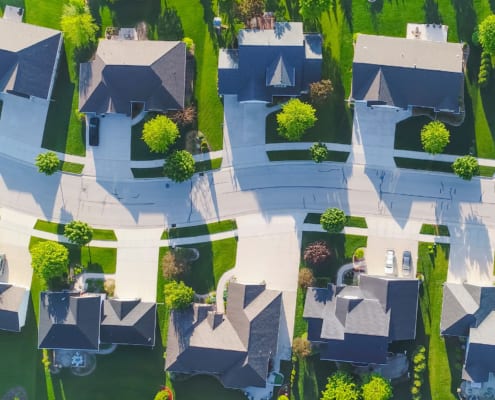 Aerial view of an HOA community. Learn how self-managed HOA software can help your community transform its operations and save money.