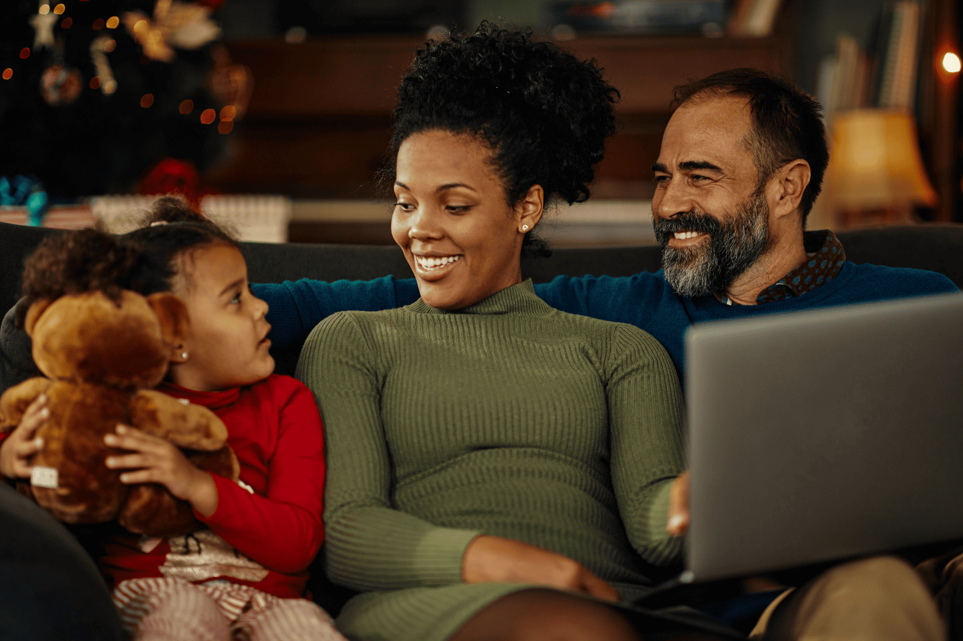 Image of a family relaxing on a sofa with a laptop. Blog article about how to increase technology usage in your HOA or condo communities.