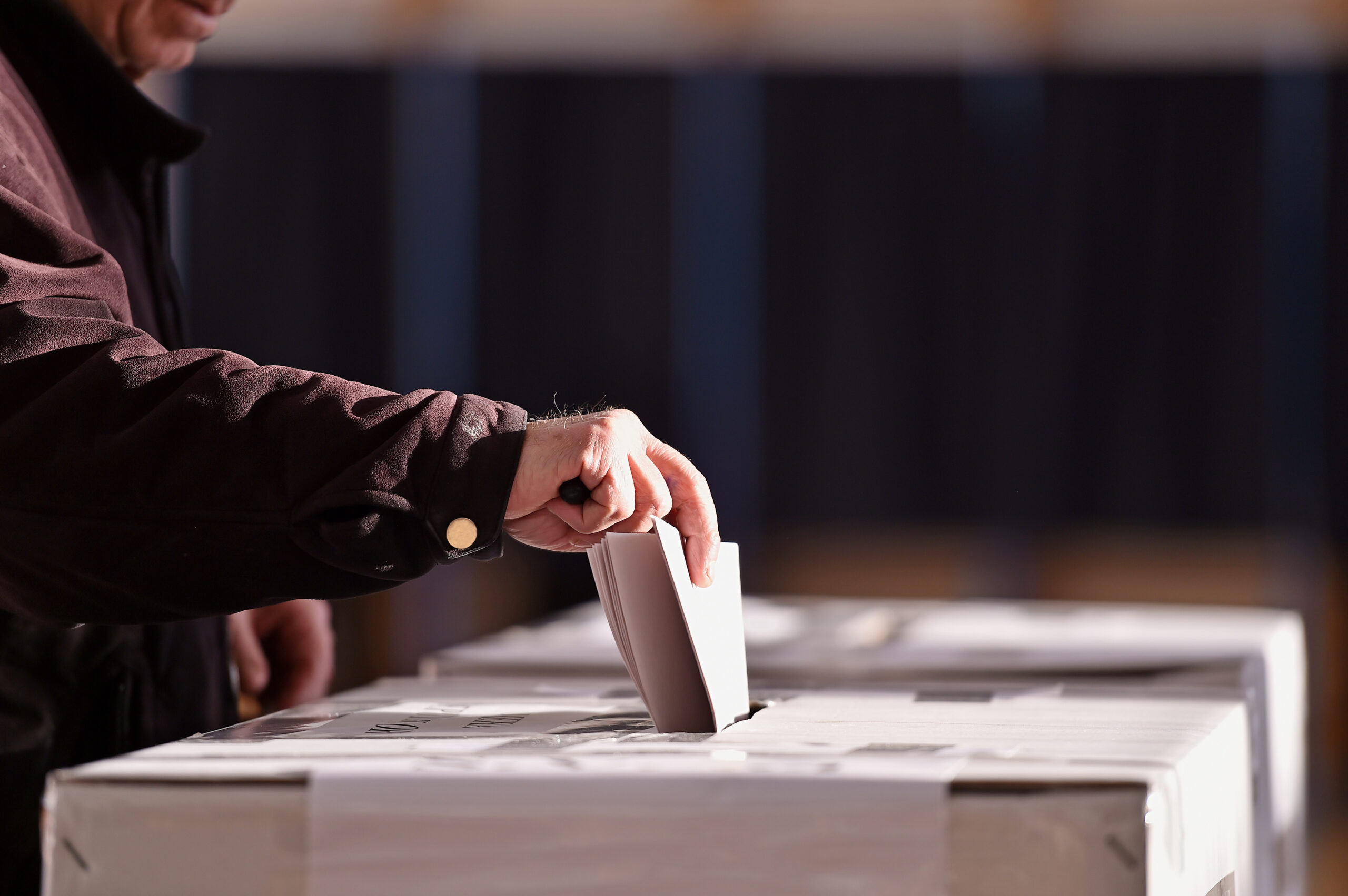 Close-up of a Man's Hand Dropping His Votes in Ballot