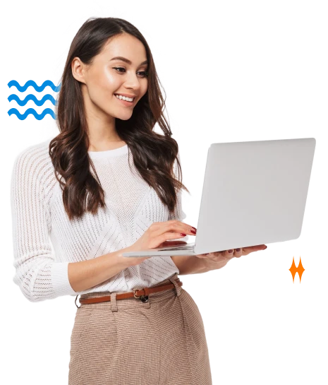 A Wide Smile Spreads Across a Girl's Face as She Views Something on Her Laptop
