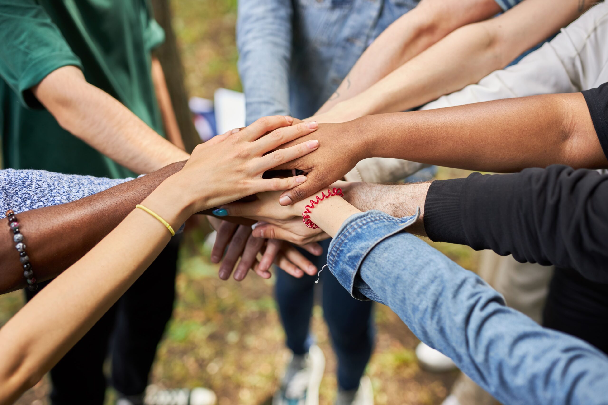 A Diverse Group Stands United, Holding Hands in a Gesture of Solidarity and Connection